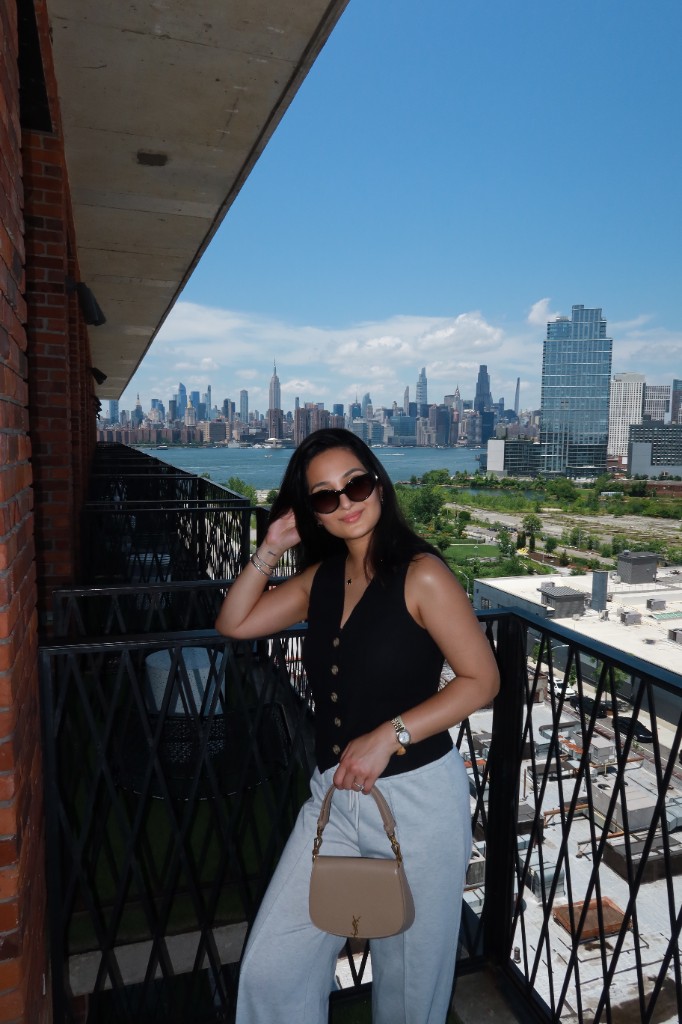 Dr. Sarah on a balcony overlooking a city skyline